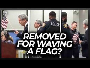 Read more about the article This State’s ‘Prop Ban’ Used to Justify Police Removing Man Waving US Flag at City Meeting